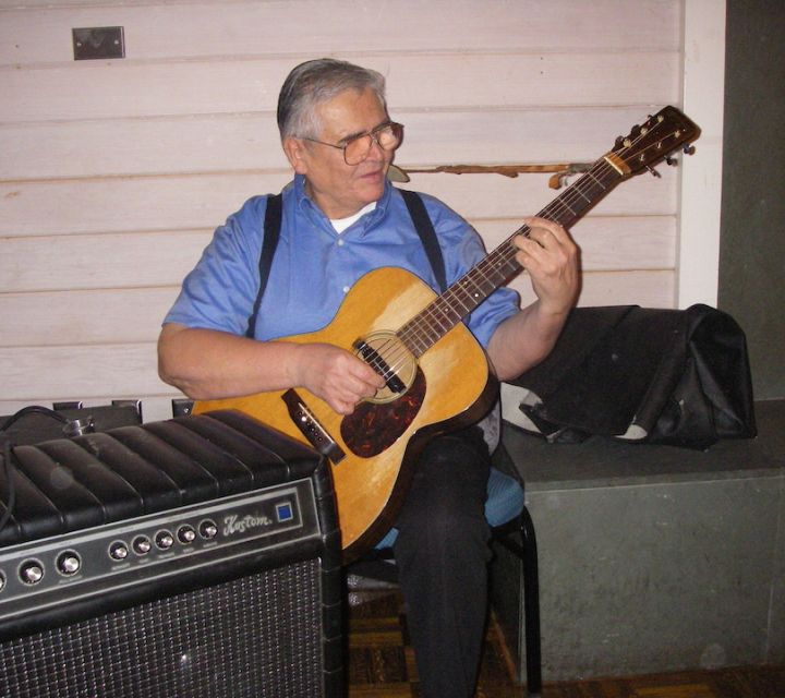 A man playing the guitar